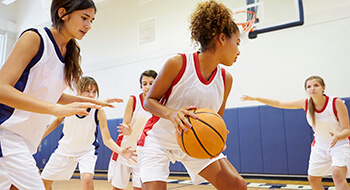 Teen girls playing basketball