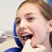 Young girl examined by dentist