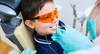 Young boy in dental chair examined by doctor
