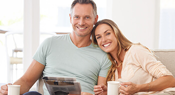 Older couple with healthy smiles on couch