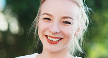 Young girl with braces smiling