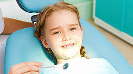 Young girl in dental chair for checkup