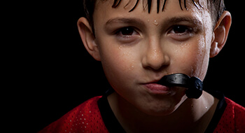 Young boy with an athletic mouthguard