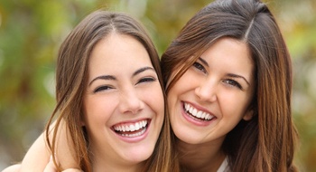 Two females hugging and smiling