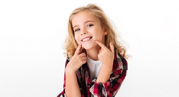 A little girl pointing at her smile