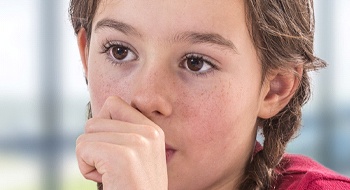 A young girl sucking her thumb