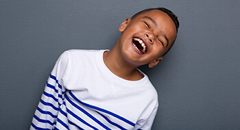 Laughing young boy with healthy smile