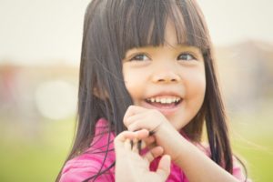 young girl brown hair smiling